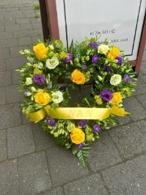 Open heart with vibrant yellow roses and purple lisianthus on stand Name on sash is optional